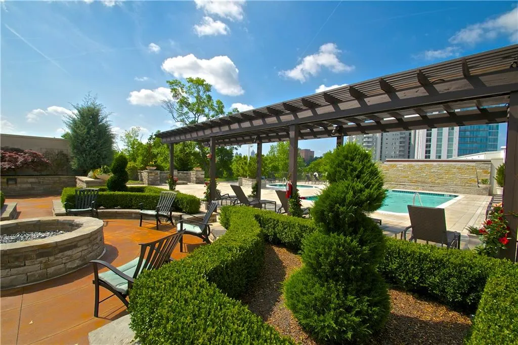 View of Community / terrace with pool, an outdoor fire pit, and a pergola