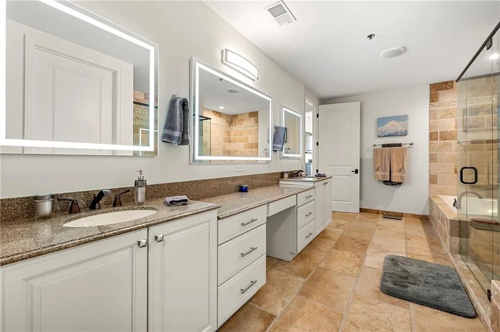Primary Full bath featuring visible vents, vanity, and a shower stall