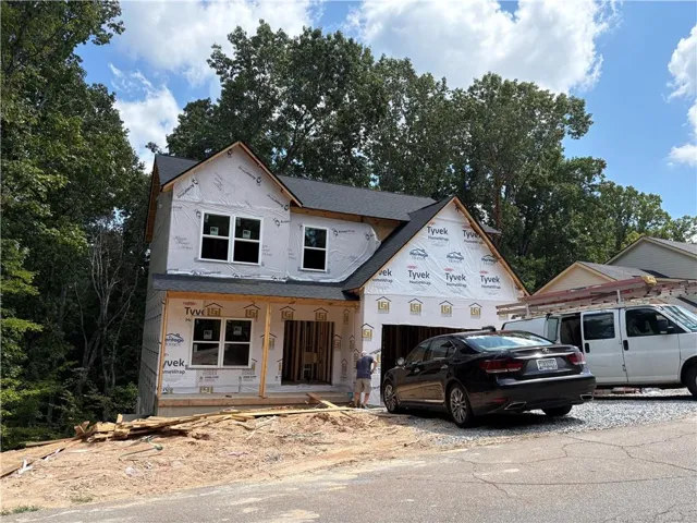 Two-story construction featuring a gable roof and multiple windows