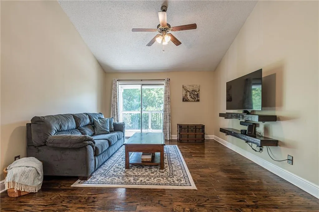 featuring high vaulted ceiling, tv built-in unit, and engineered hardwood flooring throughout.