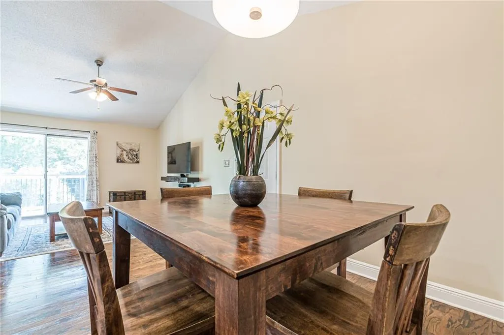 Dining room featuring high vaulted ceiling and open floor plan.