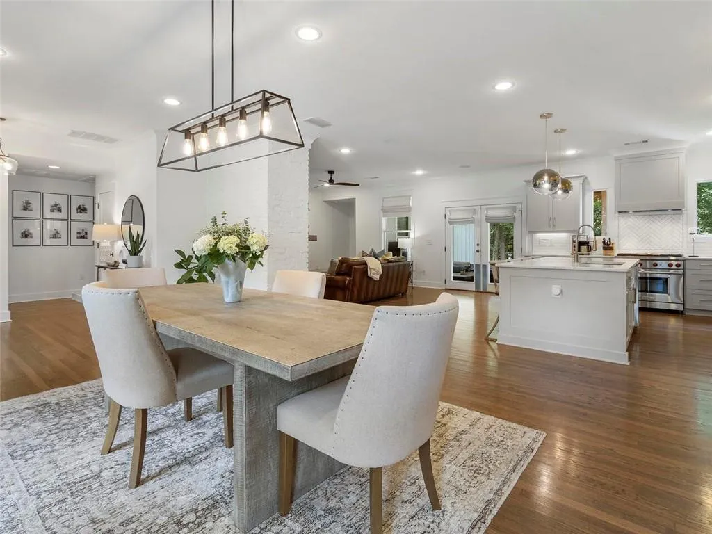 Dining area with sink, hardwood / wood-style flooring, ceiling fan, and french doors