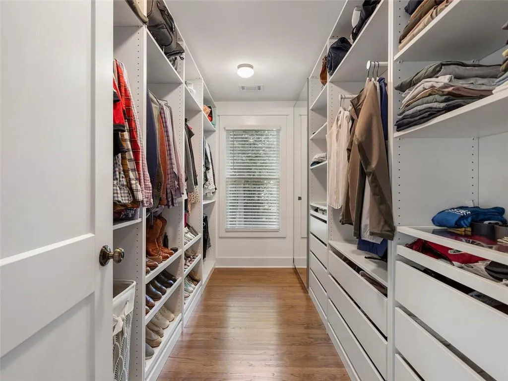 Spacious closet with hardwood / wood-style floors