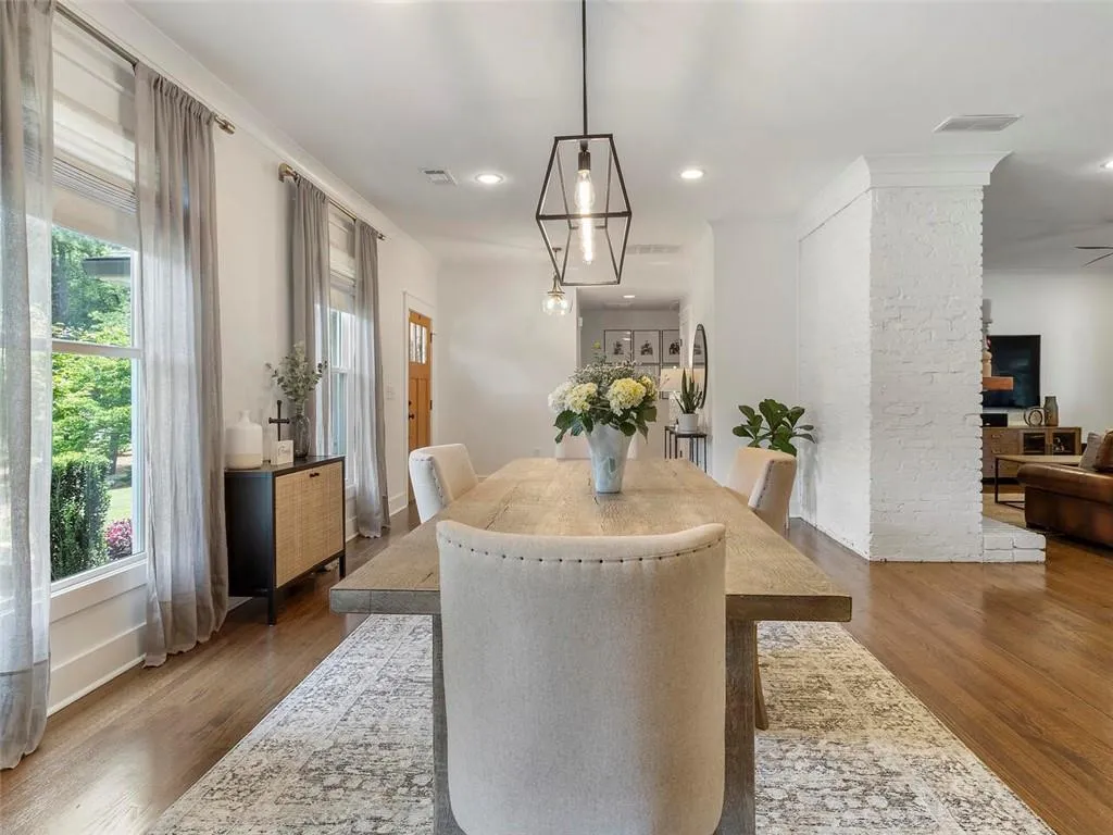 Dining area featuring dark hardwood / wood-style flooring and brick wall