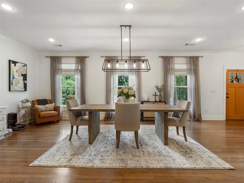 Dining space with dark hardwood / wood-style flooring and crown molding