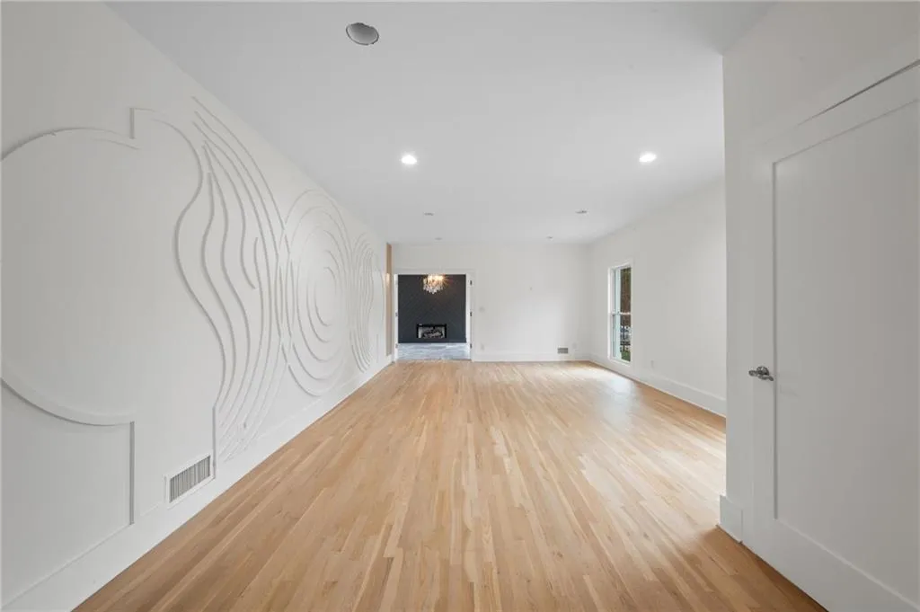 Empty room with light hardwood / wood-style flooring