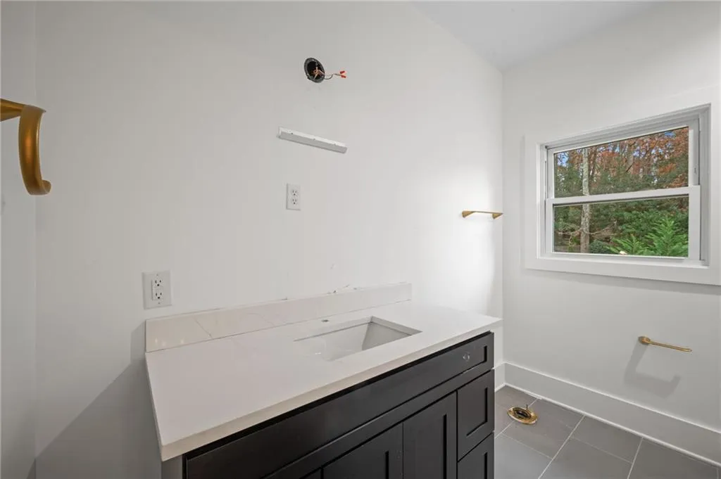 Bathroom with tile patterned floors and vanity