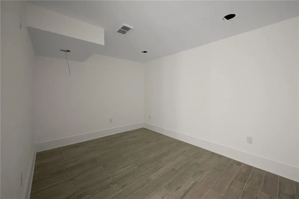 Spare room featuring dark wood-type flooring