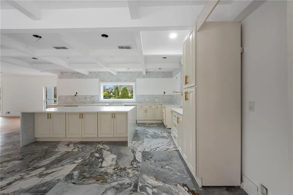 Bathroom with backsplash and beamed ceiling