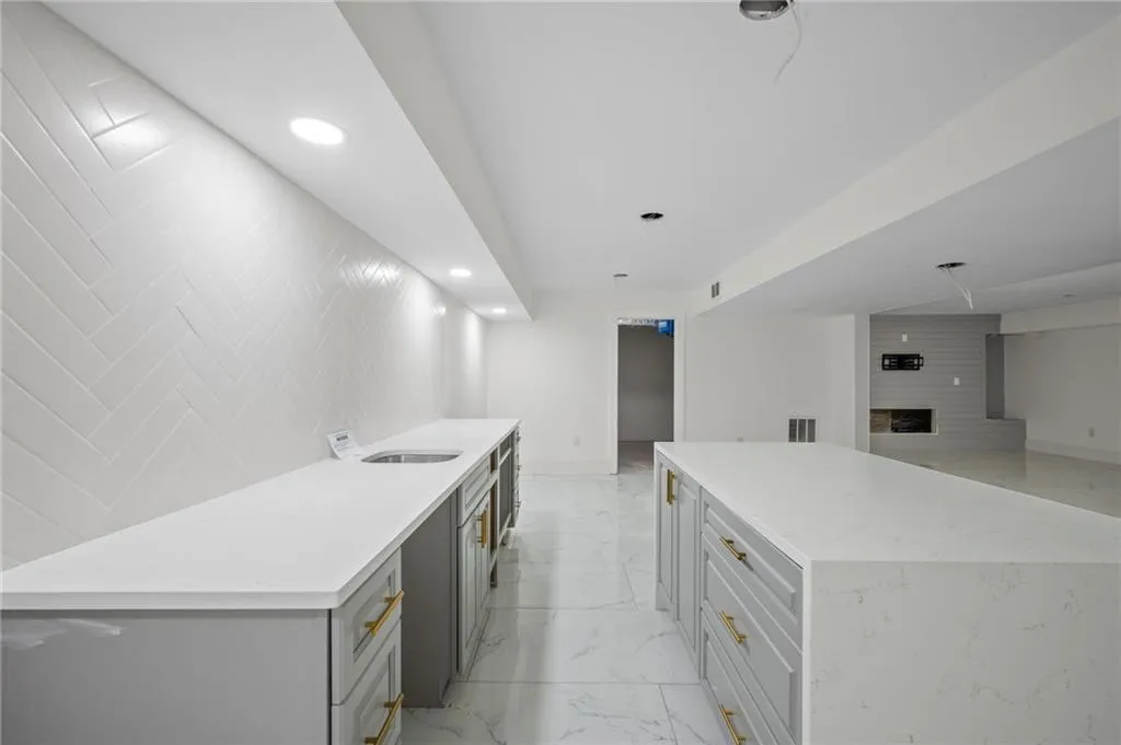 Kitchen featuring a center island, sink, and a fireplace