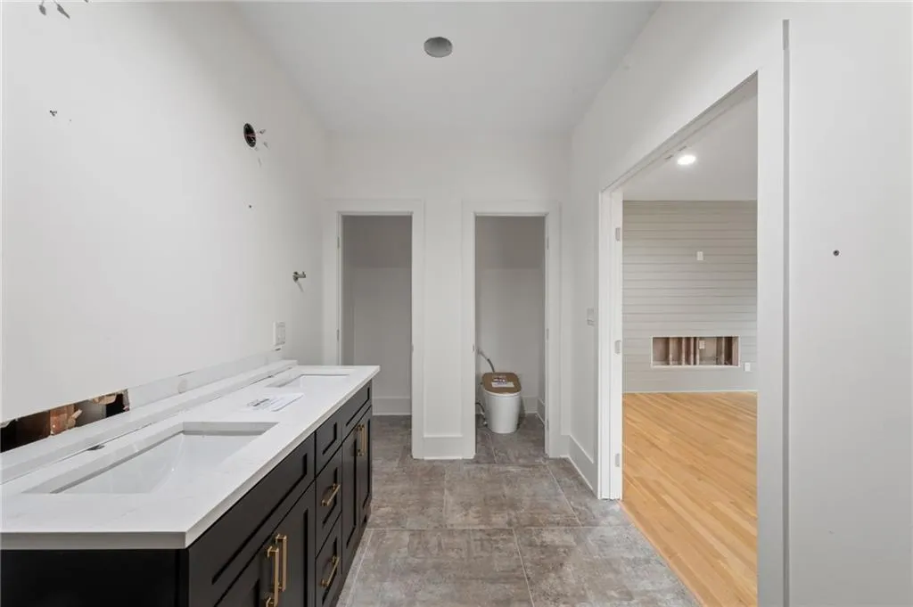 Bathroom featuring wood-type flooring, vanity, and toilet