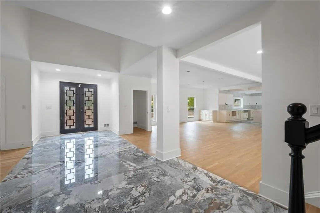 Foyer featuring beam ceiling and light wood-type flooring
