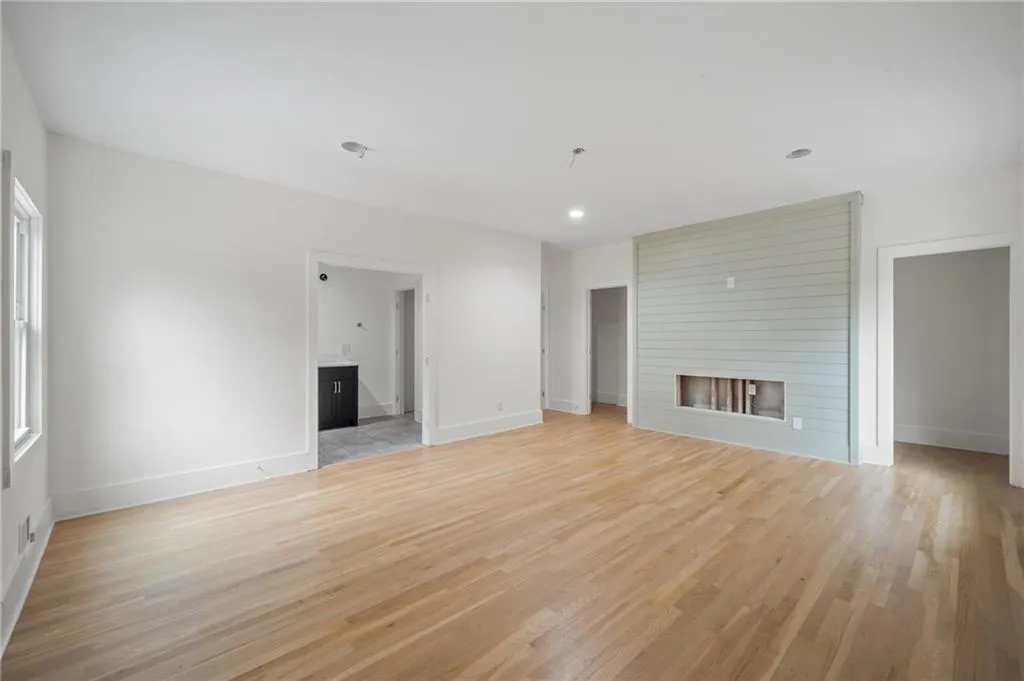 Unfurnished living room with a fireplace and light hardwood / wood-style floors