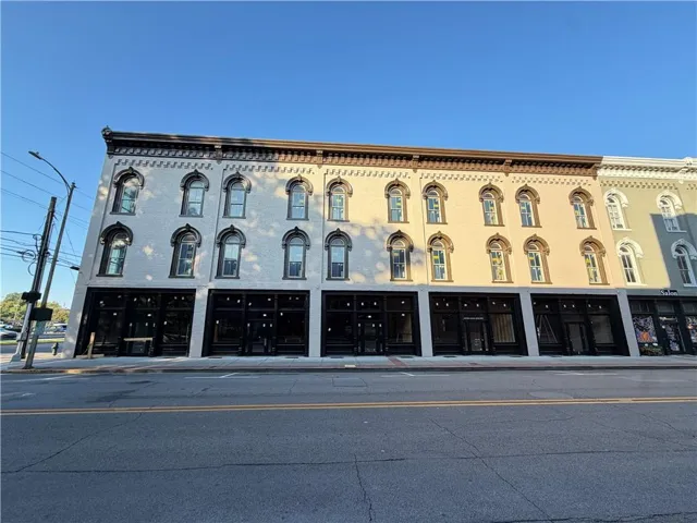 Multi-story facade featuring arched windows, decorative cornices, and a prominent storefront level