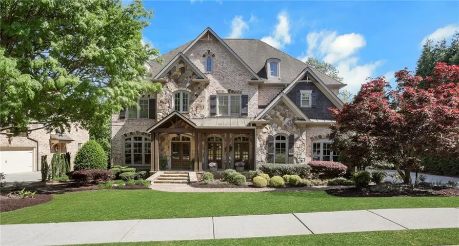 A stunning four sided brick and stone estate in the gated Turnberry community.