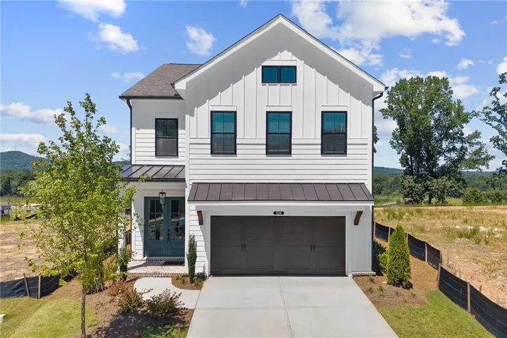 Modern farmhouse exterior with white vertical and horizontal siding
