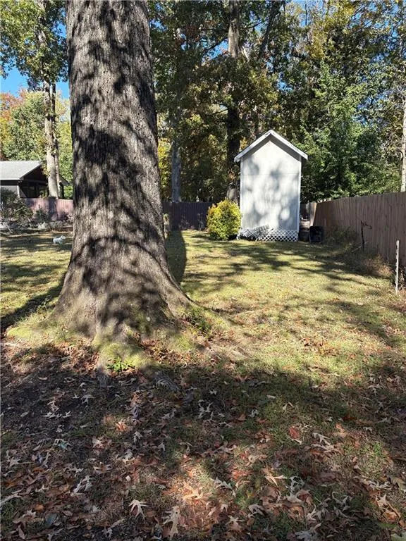 Fenced backyard with a storage shed