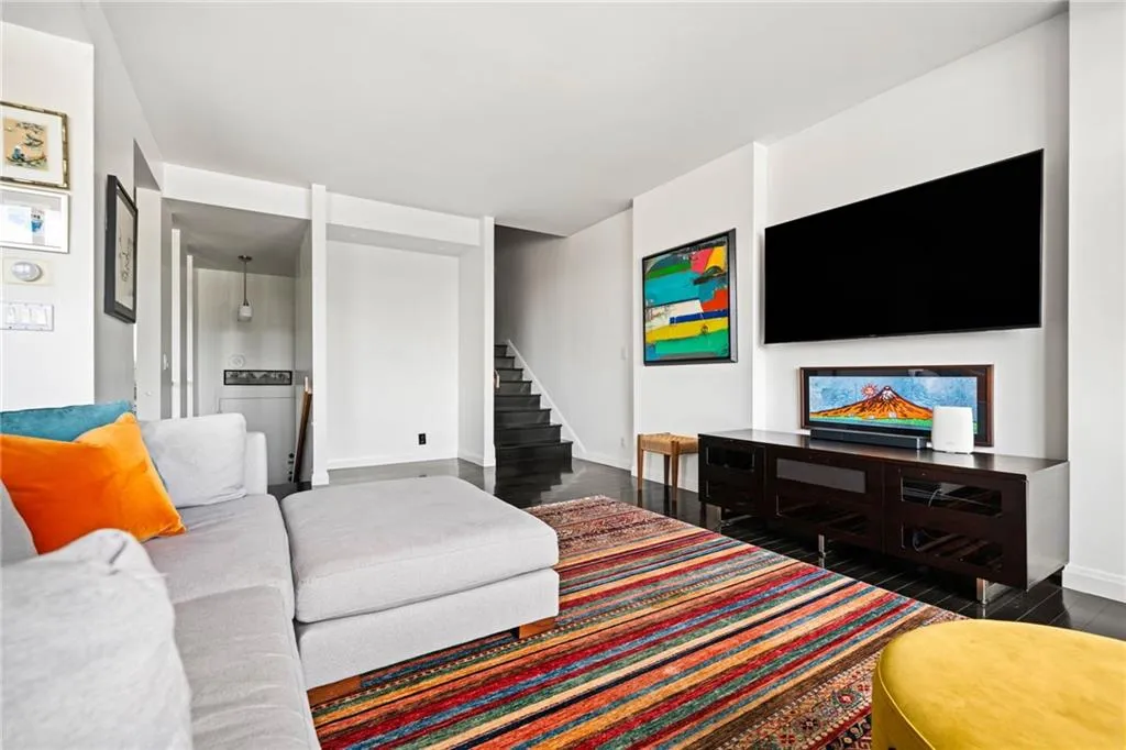 Main living room with bar area and stairs up to 2nd level