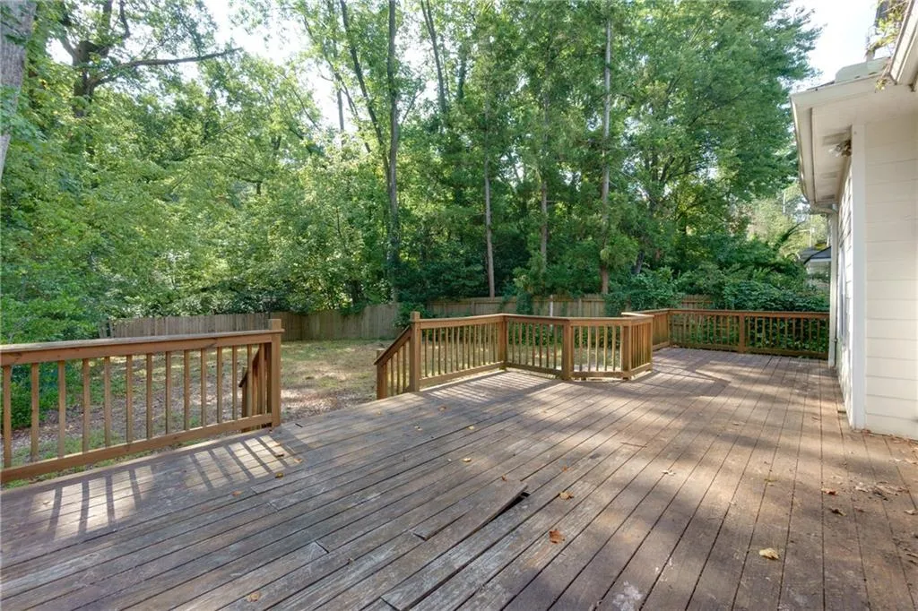 Wooden deck featuring a fenced backyard