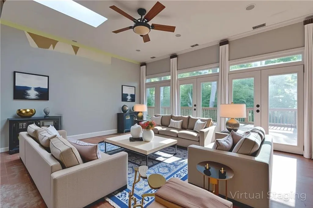 Living room with french doors, a ceiling fan, and a skylight