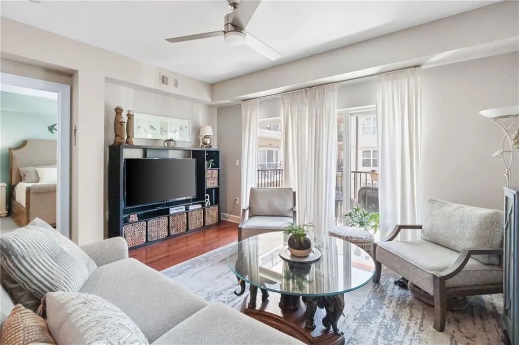Living room featuring dark hardwood / wood-style flooring and ceiling fan