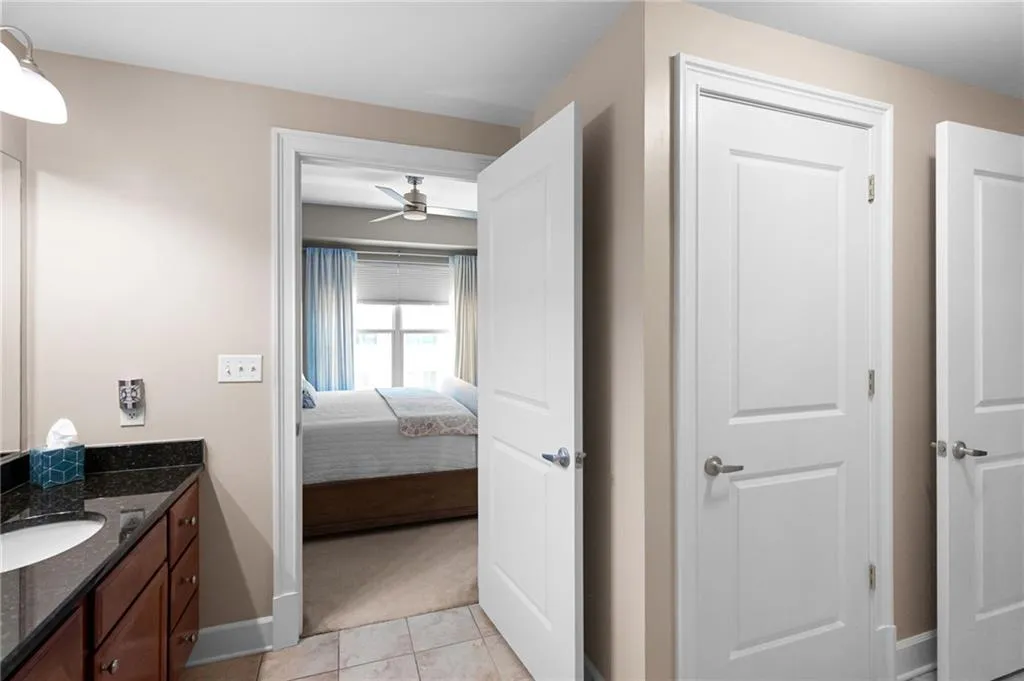 Bathroom with ceiling fan, tile floors, and vanity