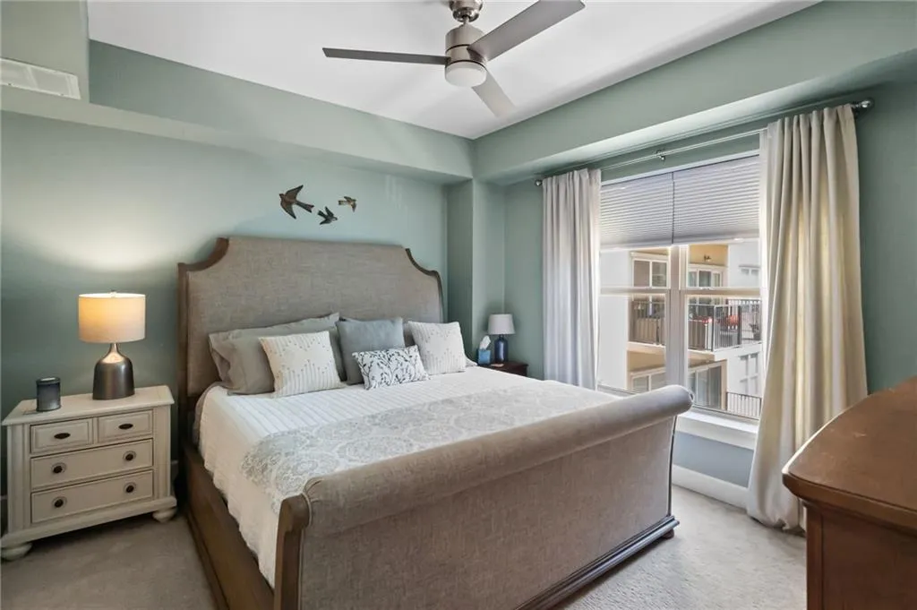 Bedroom featuring light carpet and ceiling fan