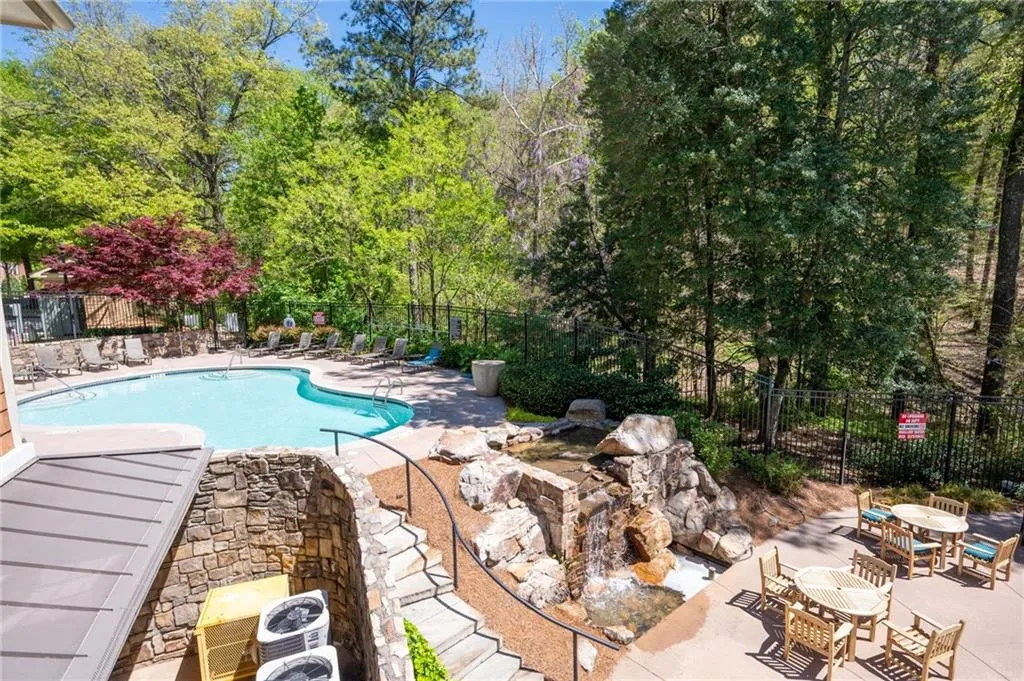 View of pool featuring central AC unit and a patio