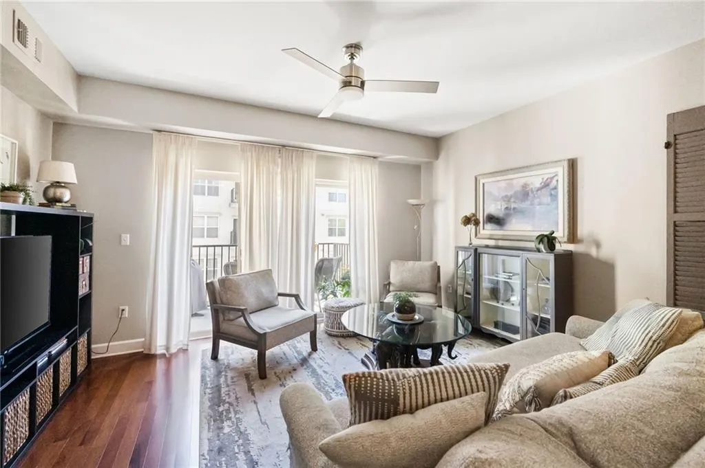 Living room with ceiling fan and dark hardwood / wood-style flooring