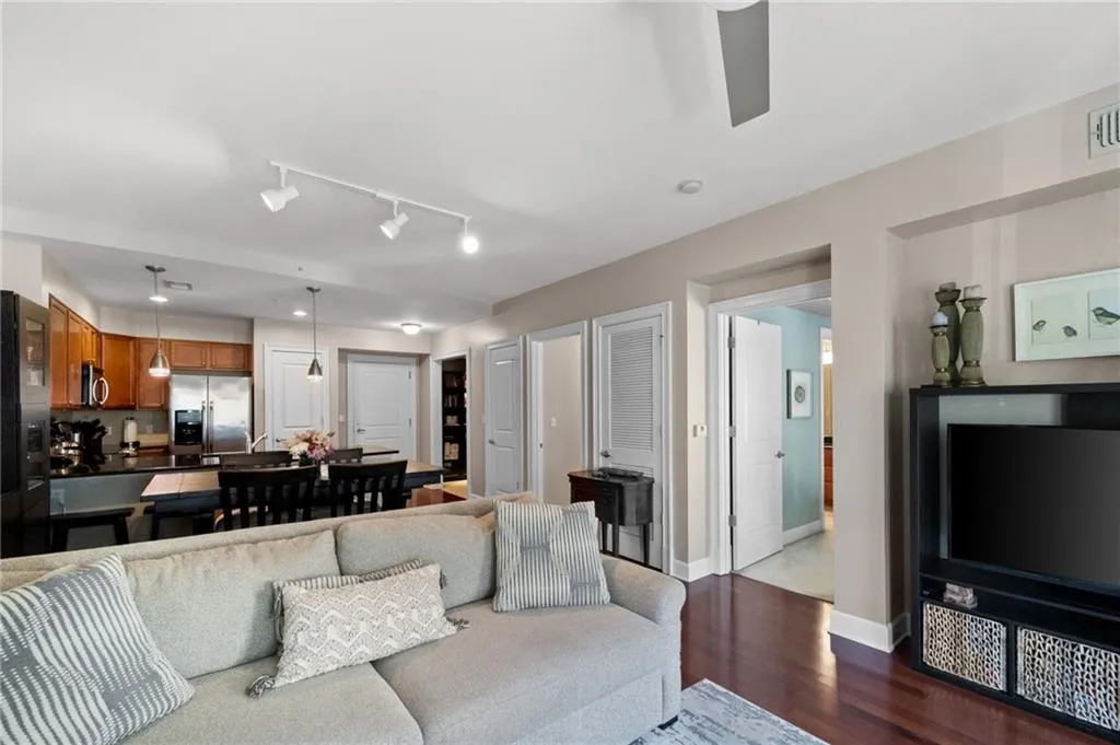 Living room with track lighting and light wood-type flooring