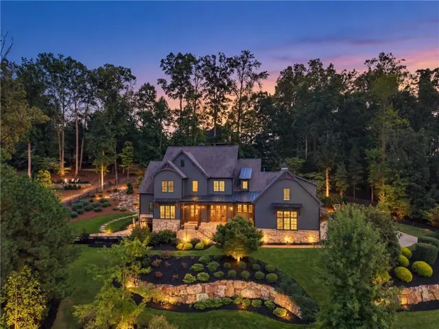 Custom home with dark siding and stone accents
