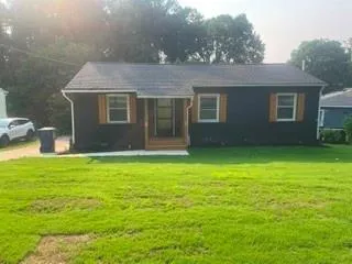Siding exterior with contrasting window shutters and a gabled roof
