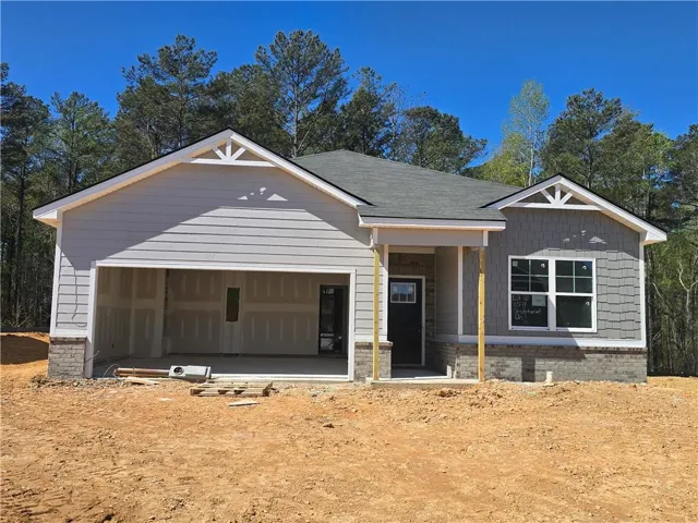 View of front of property with covered porch and an attached garage