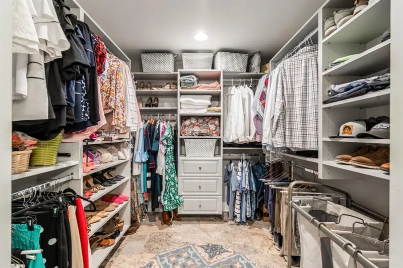 Fabulous walk in closet in primary bedroom with tons of built ins.
