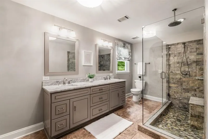 Spa-like and updated primary bathrooom features a double vanity, and huge walk-in shower