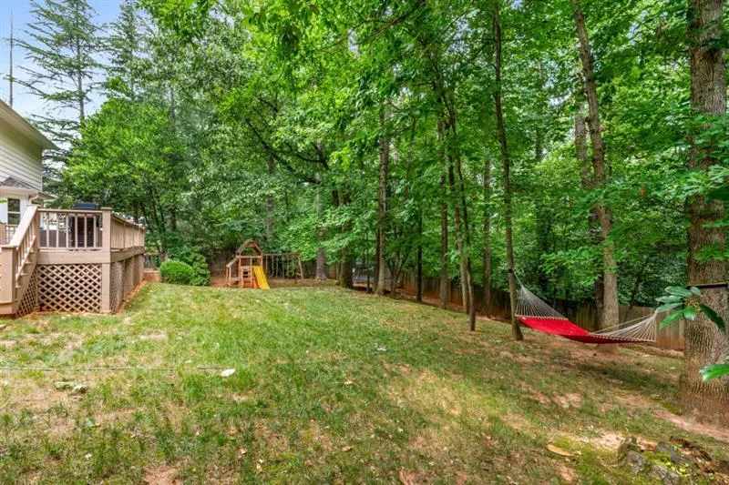 Rear view of home and shaded backyard.