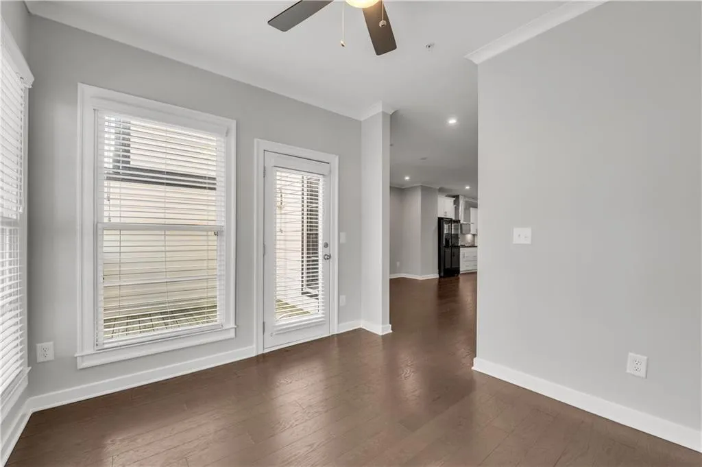 Spare room with ceiling fan, dark wood finished floors, recessed lighting, crown molding, and fire sprinkler in ceiling