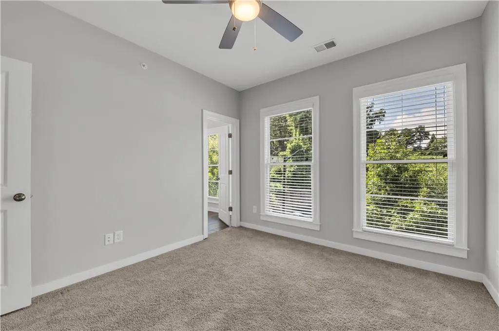 Empty room with carpet and a ceiling fan