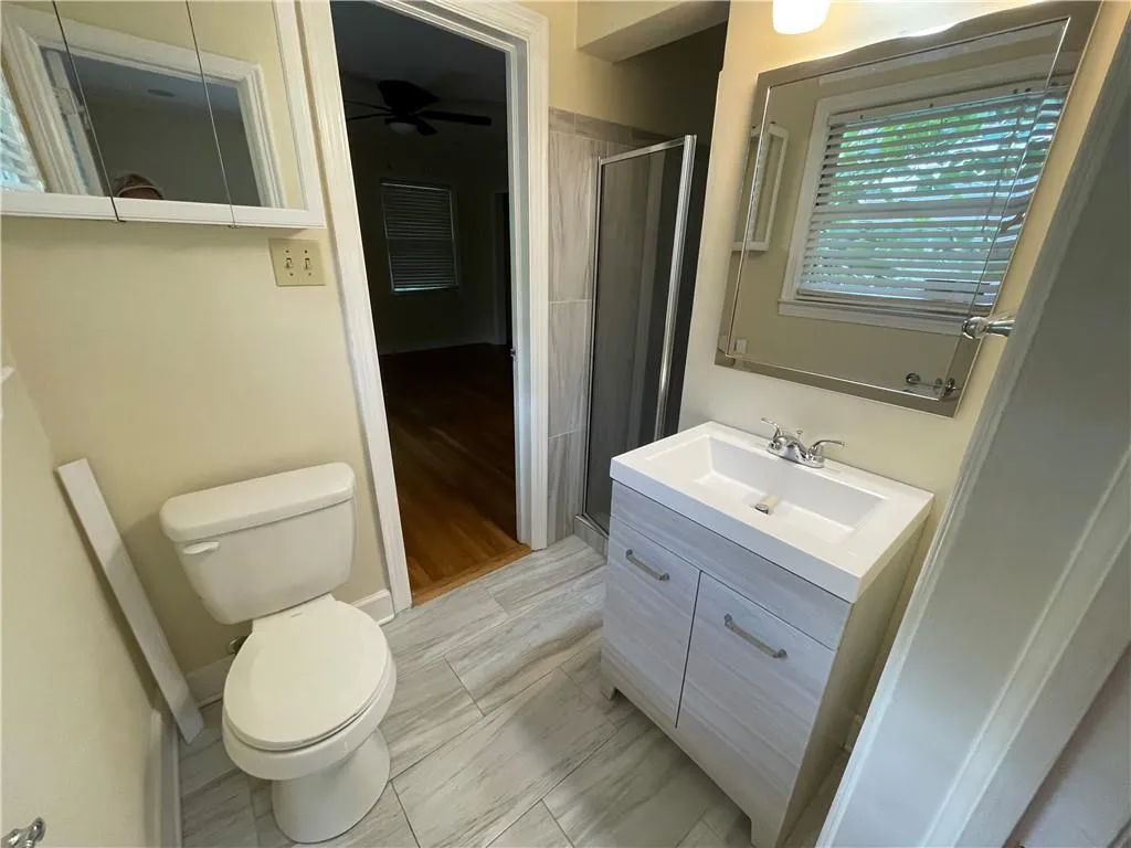 Shared ensuite bathroom for Bedrooms 2&3 with Shower, hip tile and cabinet