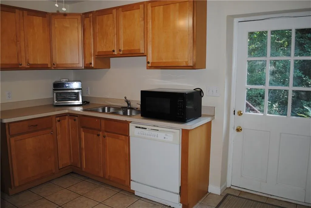 Terrace level Full Kitchen with maple cabinets and exterior entrance for tenant or to go to yard/firepit