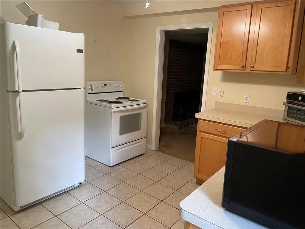 Terrace level Full Kitchen featuring tile flooring and white appliances