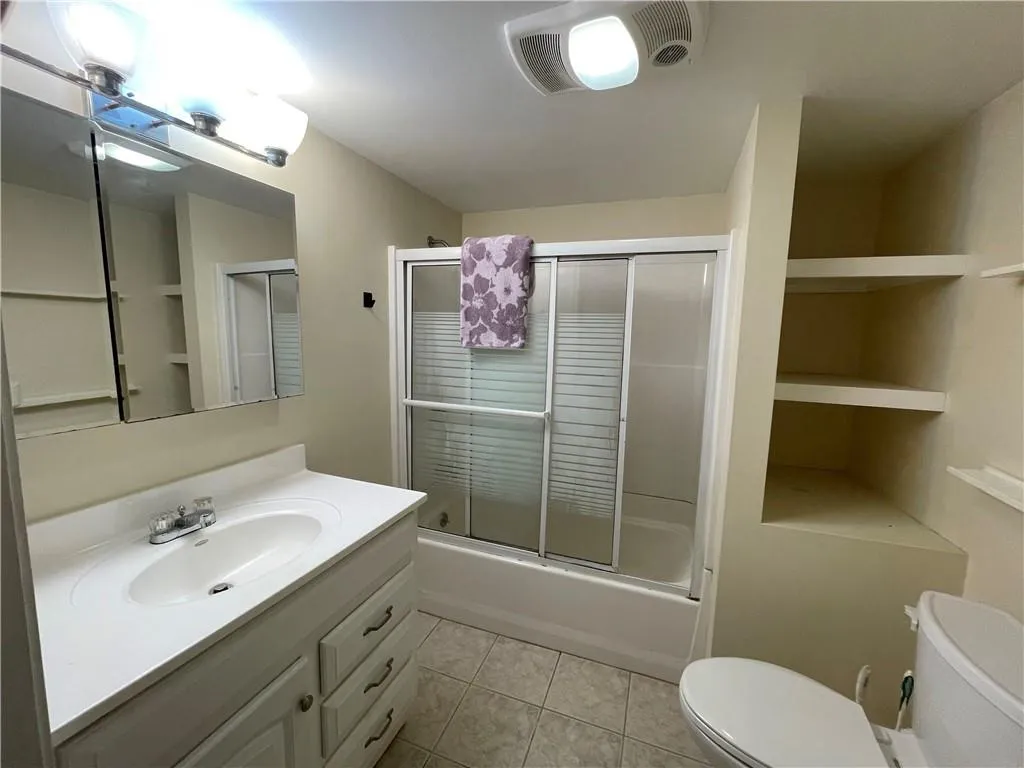 Terrace level - Full bathroom featuring tile  and tub / shower combo with glass door