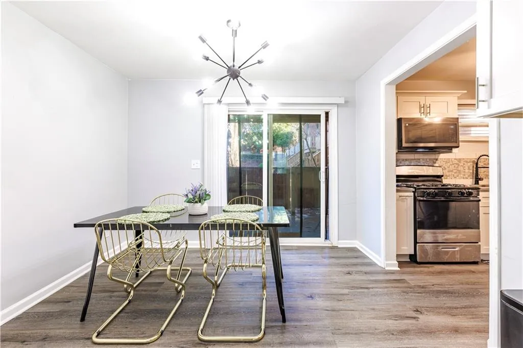 Dining room with wood-type flooring and an inviting chandelier