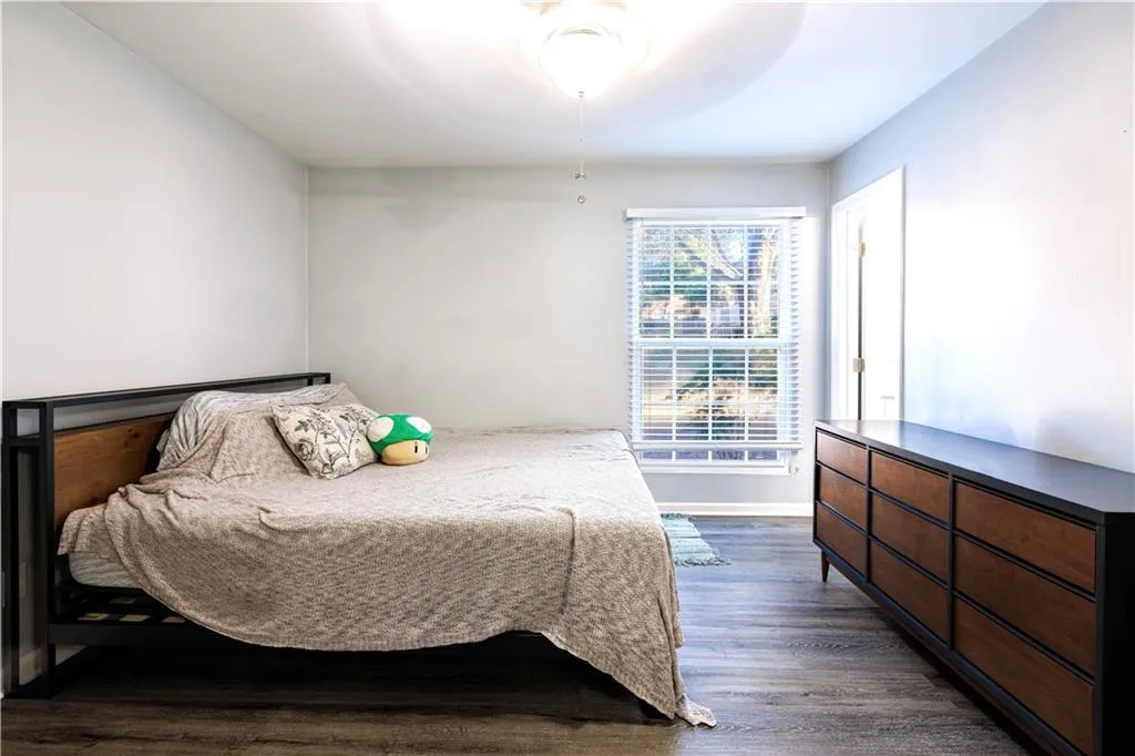 Bedroom featuring ceiling fan and dark hardwood / wood-style floors