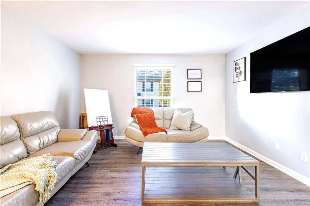 Living room with dark hardwood / wood-style flooring