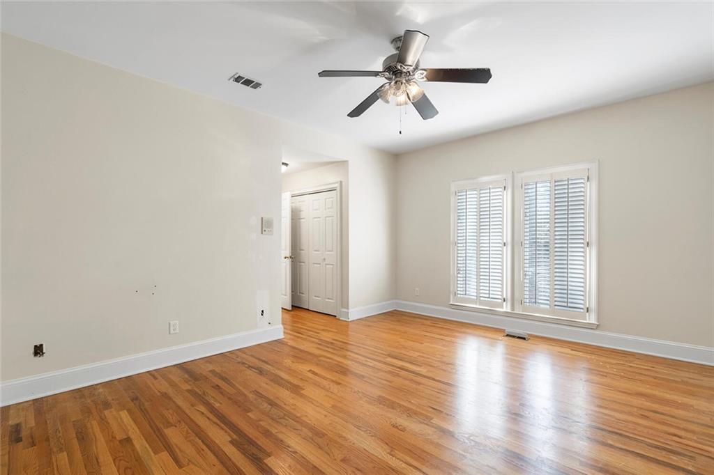 Empty room with light wood-type flooring and ceiling fan