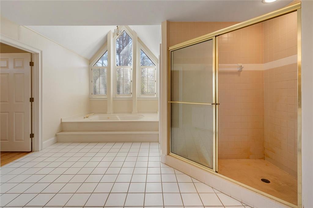 Bathroom featuring separate shower and tub and tile flooring