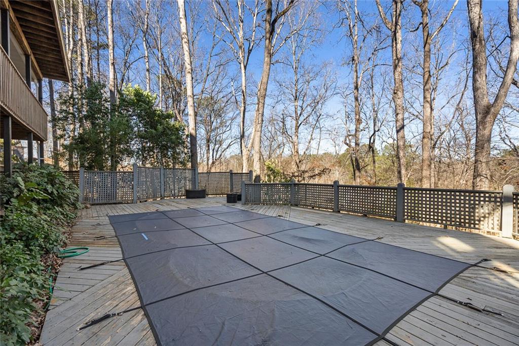 View of pool featuring a wooden deck