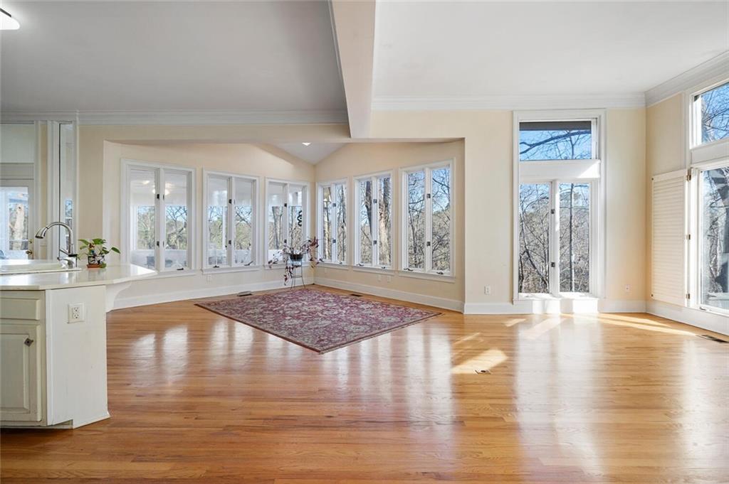 Entrance foyer featuring ornamental molding, sink, light wood-type flooring, and beamed ceiling