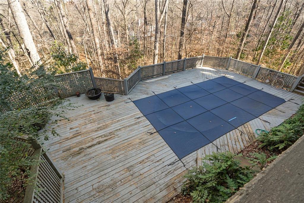 View of pool featuring a wooden deck